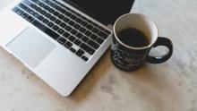 Macbook pro and coffee cup